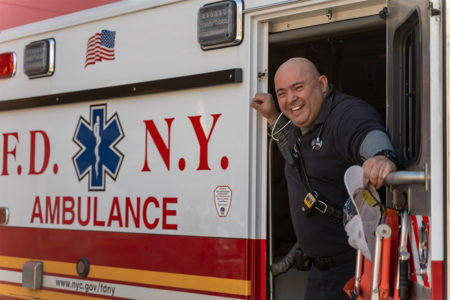 NYFD paramedic leaning outside an ambulance