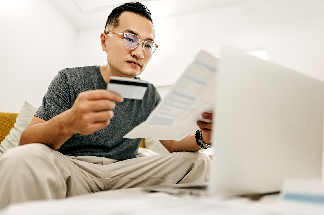 Man paying bills with credit card